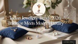 Luxury Indian gold and diamond jewellery collection for 2026 including necklaces, rings, and pearl earrings displayed on navy blue velvet cushions and marble.