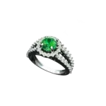 Angled view of the Tribhanga emerald halo ring with a split shank band.
