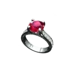 Angled view of the Tribhanga round ruby ring showing the side scroll details.