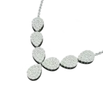 Angled side view of the Tribhanga Teardrop White Gold Necklace, highlighting the pave cluster setting and central drop against a dark background.